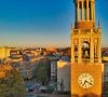 Bell tower with a clock at sunset, overlooking campus and trees, near Downtown Chapel Hill dining and vibrant Chapel Hill restaurants.