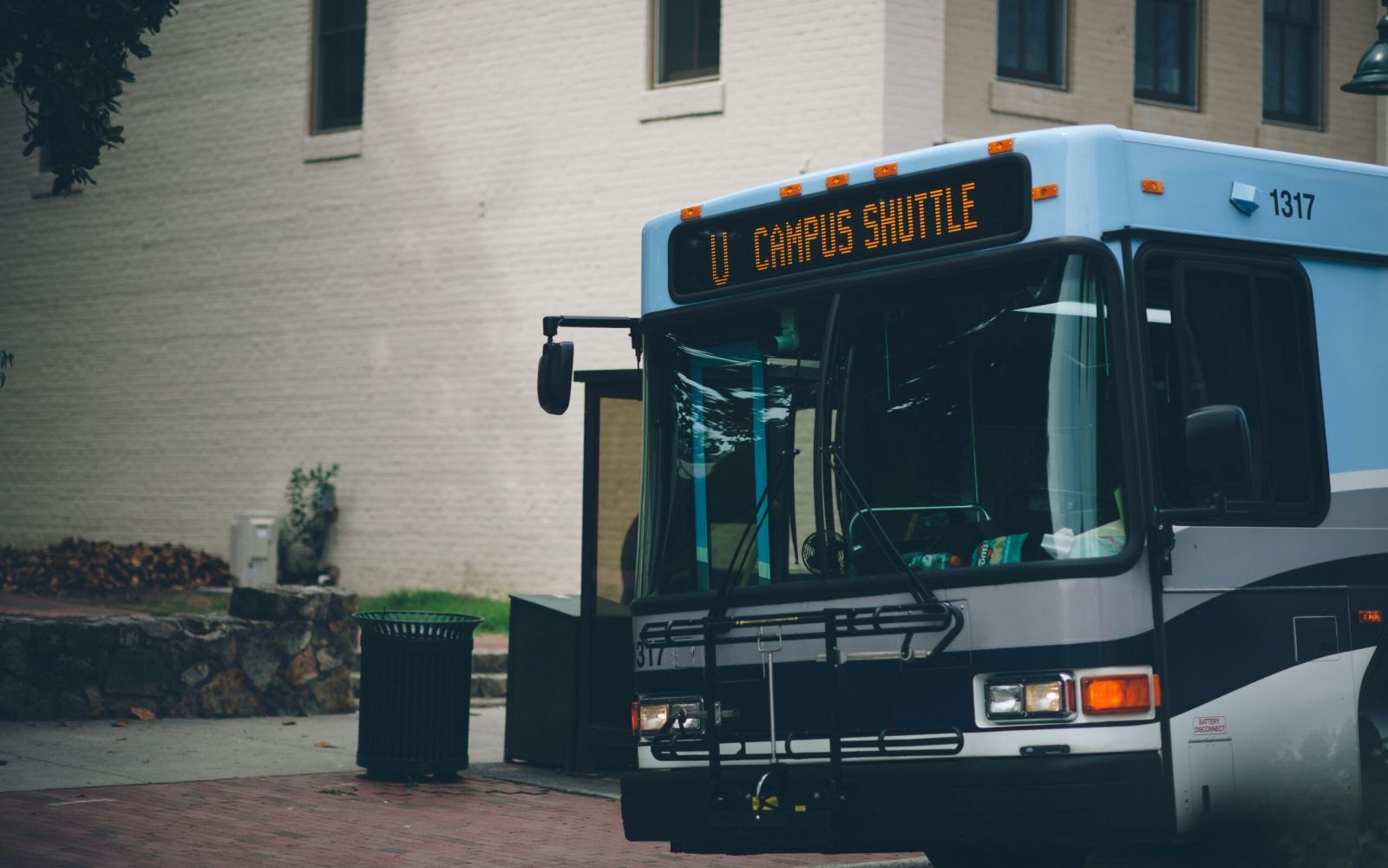 Blue and white bus with "UT Campus Shuttle" displayed, parked near Carolina Square—a spot popular among UNC students.
