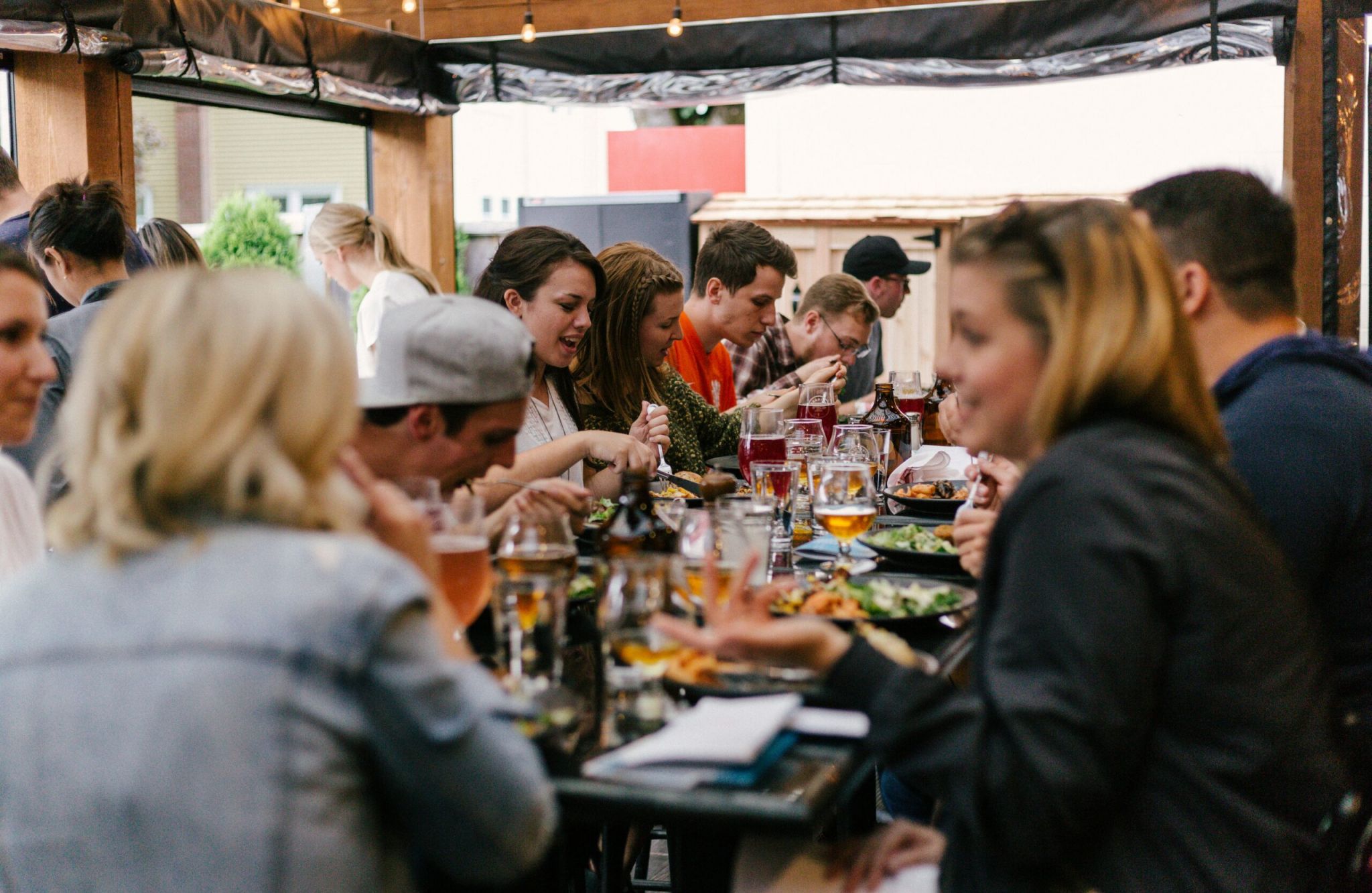 The Vue Charlotte, NC apartment neighborhood people dining outdoor at a restaurant and toasting wine glasses