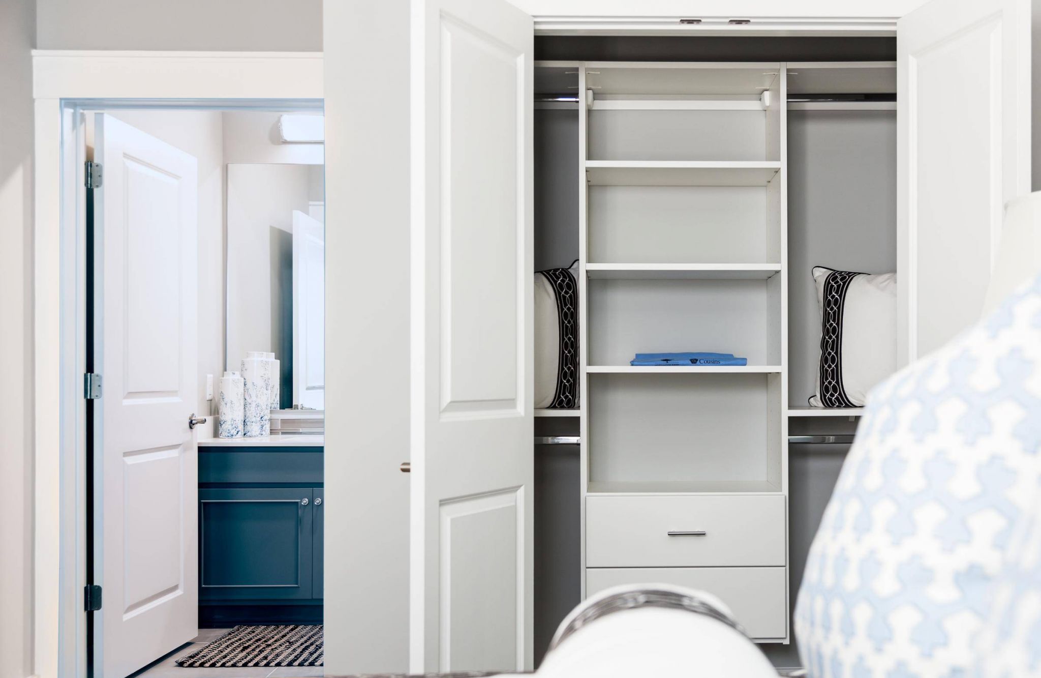 1-bed apartment bedroom with large bed, ceiling fan, carpet, dresser, and large closet