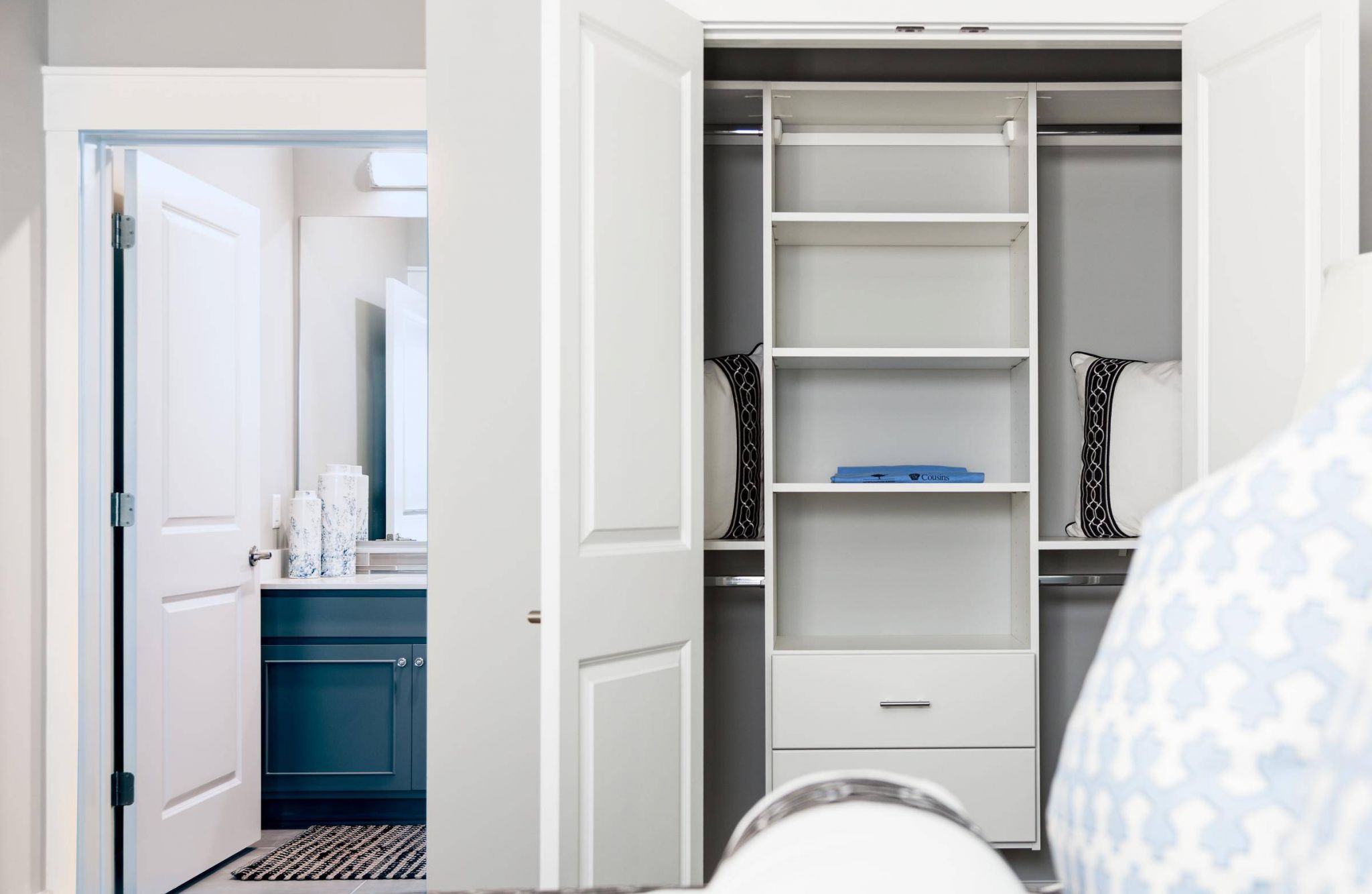 1-bed apartment bedroom with large bed, ceiling fan, carpet, dresser, and large closet